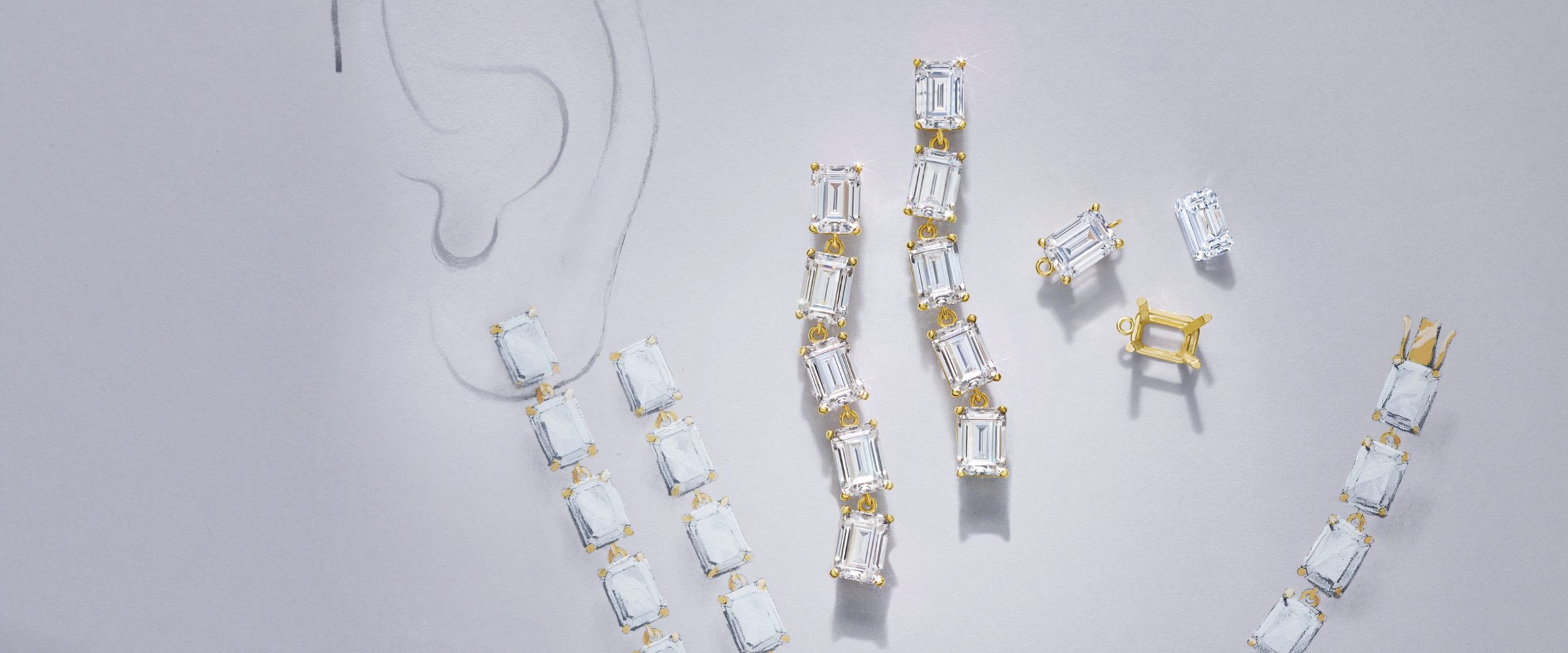 Emerald-cut drop earrings and tennis bracelet beside a pencil sketch of the design